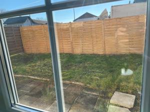 a window view of a backyard with a fence at D&D Apartment in Kolbermoor