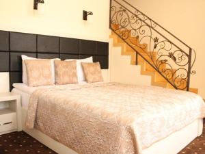 a bedroom with a large bed and a staircase at Jermuk Verona Resort in Jermuk