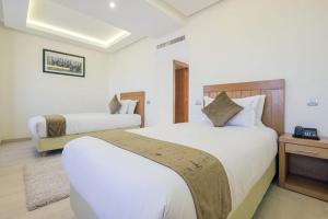 Postel nebo postele na pokoji v ubytování Hotel Ayoub & Spa