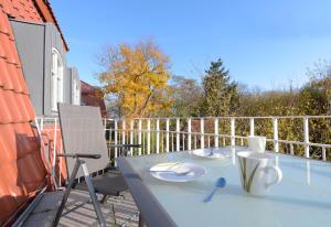 a balcony with a table and chairs on a patio at "Villa Sonnengarten", FeWo 3 in Boltenhagen