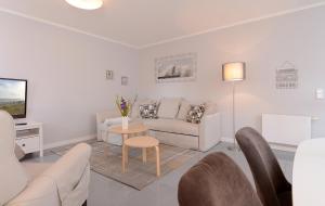 una sala de estar con un sofá y una mesa en "Villa Sonnengarten", FeWo 3, en Boltenhagen