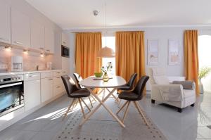 a kitchen and dining room with a table and chairs at "Villa Sonnengarten", FeWo 3 in Boltenhagen