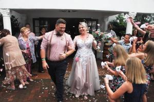 a bride and groom walking down the aisle at their wedding at Fountain Villa in Klerksdorp