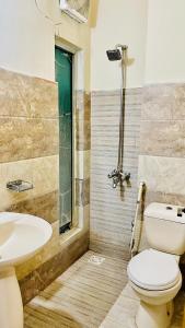 a bathroom with a toilet and a sink at Plaza Inn Hotel in Rahimyar Khan