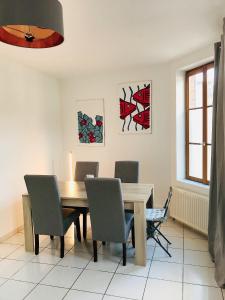 a dining room with a wooden table and chairs at Le 61 bis in Saint-Valery-sur-Somme