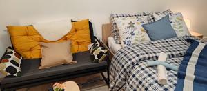 a room with a bed and pillows on a bench at Magnifique Appartement Lille WIFI Parking by Servallgroup in Mons-en-Baroeul