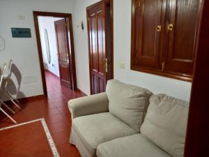 a living room with a couch and a wooden cabinet at Casa Ramos in Arrecife