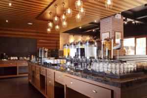 a bar in a restaurant with glasses on a counter at Rambuttri Village Plaza in Bangkok