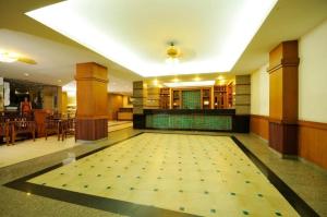a large room with a tile floor with a swimming pool at Rambuttri Village Plaza - SHA Extra Plus in Bangkok