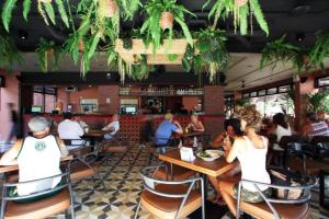 a group of people sitting at tables in a restaurant at Rambuttri Village Plaza in Bangkok