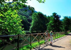 a couple of people walking a horse on a bridge at Casa Rural Oroimena in Andoain