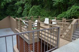 a row of wooden benches in a wooded area at Edgewater Hotel and Conference Center in Gatlinburg