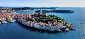 an island in the middle of the water with buildings at Angelo d'Oro Heritage Hotel in Rovinj +57 photos