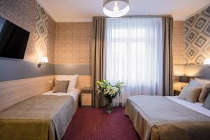 Łóżko lub łóżka w pokoju w obiekcie Hotel Kazimierz