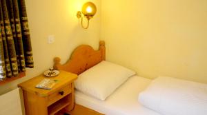 Postel nebo postele na pokoji v ubytování Casa Tödi Restaurant Hotel