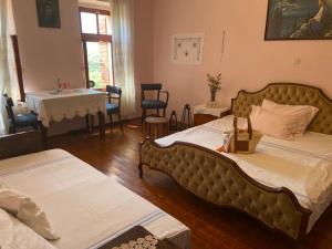 a bedroom with two beds and a table and a table at Casa Ivan B&B in Tihaljina +26 photos