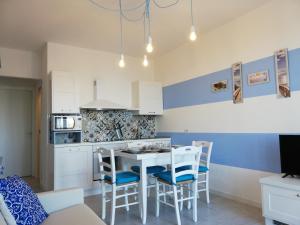 a kitchen with a table and chairs in a room at Suite Smeralda sea view in Castelsardo