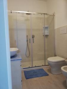 a bathroom with a shower and a toilet and a sink at Suite Smeralda sea view in Castelsardo +31 photos