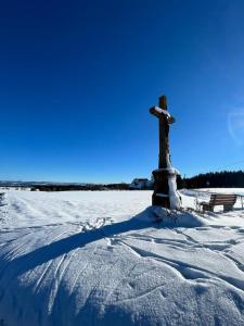 a statue of a cross in a snow covered field at Landgasthof Ritter in Villingen-Schwenningen