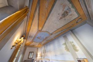 a room with a ceiling with paintings on it at B&B I Quattro Poeti in Florence