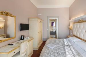 a bedroom with a large bed and a mirror at B&B I Quattro Poeti in Florence
