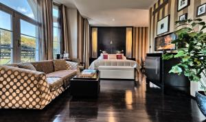 a hotel room with a bed and a couch at Baglioni Hotel London - The Leading Hotels of the World in London