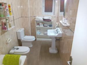 a bathroom with a toilet and a sink at casa frente al mar in San Pedro del Pinatar +20 photos