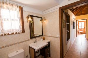 フエンカリエンテ・デ・ラ・パルマにあるCasa La Timeのバスルーム(洗面台、トイレ、鏡付)