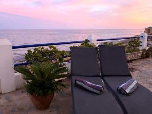 a black bench sitting on a balcony overlooking the ocean at Calahonda Beach Apartments in Sitio de Calahonda