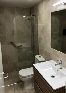 a bathroom with a toilet and a shower and a sink at Calahonda Beach Apartments in Sitio de Calahonda