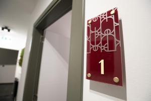 a red door with the number one on it at SAVOY residence&spa in Osijek