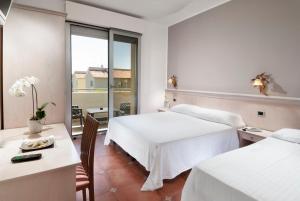 Postel nebo postele na pokoji v ubytování Hotel Le Querce