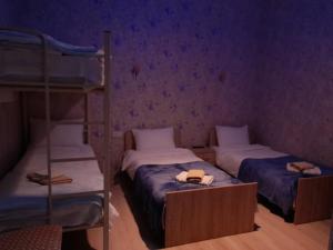 two bunk beds in a room with purple walls at AnSeZa in Kutaisi