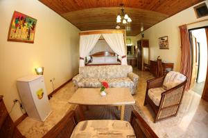 a living room with a bed and a table in a room at Charela Inn in Negril