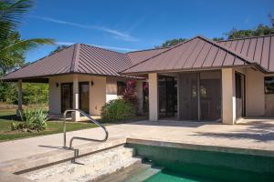 a house with a swimming pool in front of it at Legion at Morningstar Breeze Gold Standard Certified in Hopkins