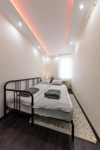 a bedroom with a bed with a led ceiling at Spacious 3-room apartment with free parking in Budapest