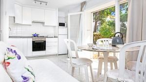 a kitchen and dining room with a table and chairs at Anc 13 BP - Llafranc in Calella de Palafrugell