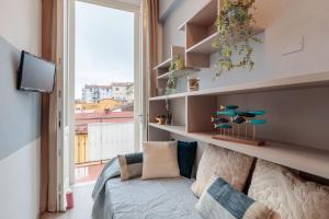 a living room with a couch and a large window at Casa Versilia Style in Viareggio