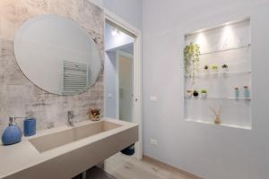 a bathroom with a sink and a mirror at Casa Versilia Style in Viareggio +31 photos