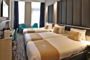 Säng eller sängar i ett rum på XO Hotels City Centre