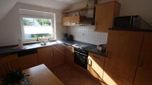 a kitchen with a sink and a stove top oven at Ferienwohnung-Amanda-1 in Bad Zwischenahn