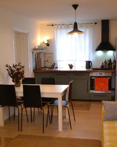 a kitchen and dining room with a table and chairs at SynytsVille in Sinitsa