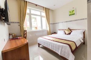 a bedroom with a bed and a television in it at Binh Minh Hotel in Vung Tau