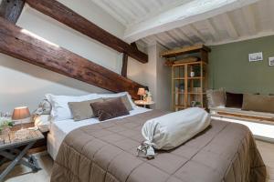 a bedroom with a large bed in a room at Casa Margherita, Residenze Seicento - Stunning view from terrace. in Lucca