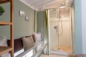 a shower with a glass door in a bathroom at Casa Margherita, Residenze Seicento - Stunning view from terrace. in Lucca