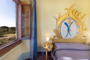 a bedroom with a bed and a painting on the wall at Villa Castiglione in Impruneta