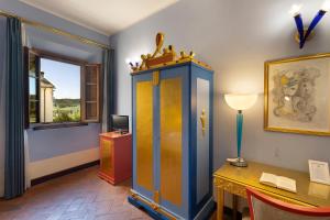 a room with a cabinet and a desk and a window at Villa Castiglione in Impruneta