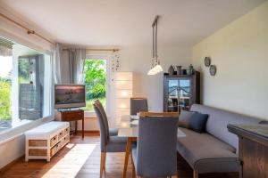 a living room with a couch and a table at Haus am Hügel in Groß Zicker