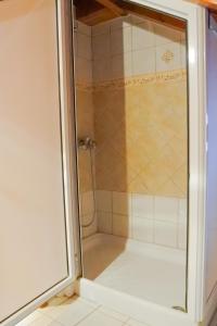 a shower with a glass door in a bathroom at Vanilla loft house Preveza in Preveza
