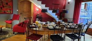 a dining room with a table with food on it at Chez La Nanie in Saint-Paul-en-Chablais